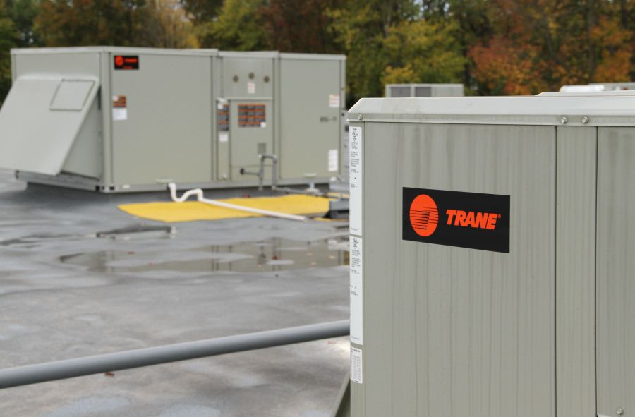 A trane unit on the roof of an industrial building.