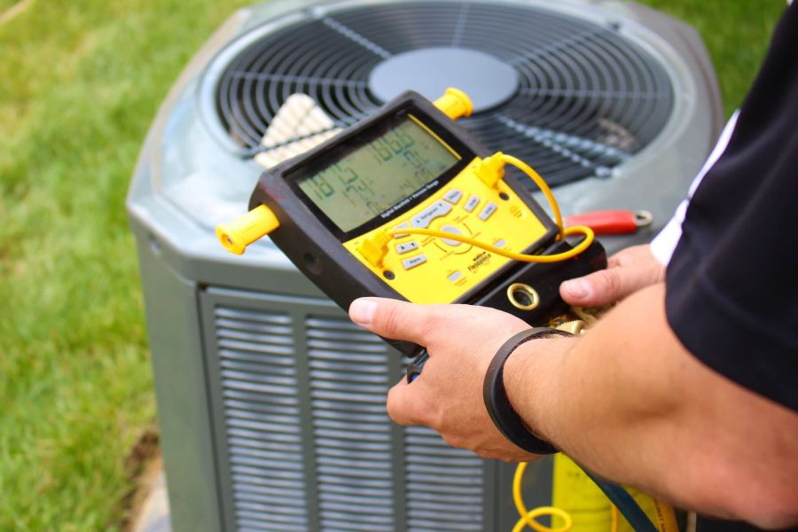 A person is checking the air conditioner