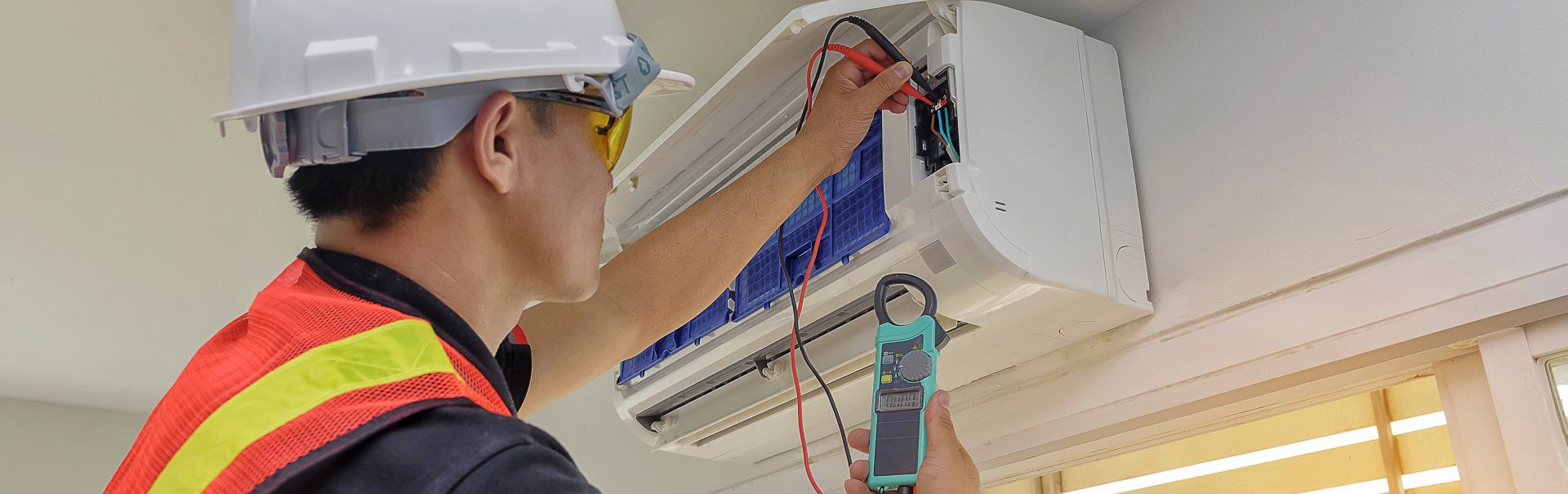 A person is working on an air conditioner.